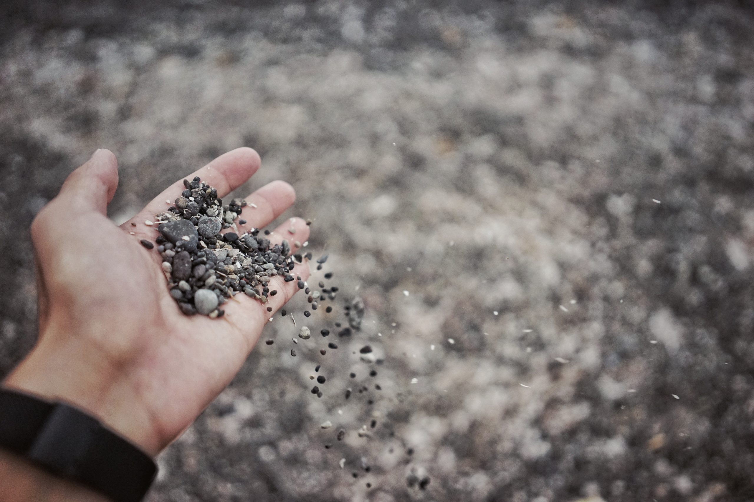 person with gravel in their hand