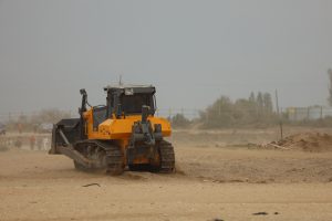 Tractor driving in the sand 